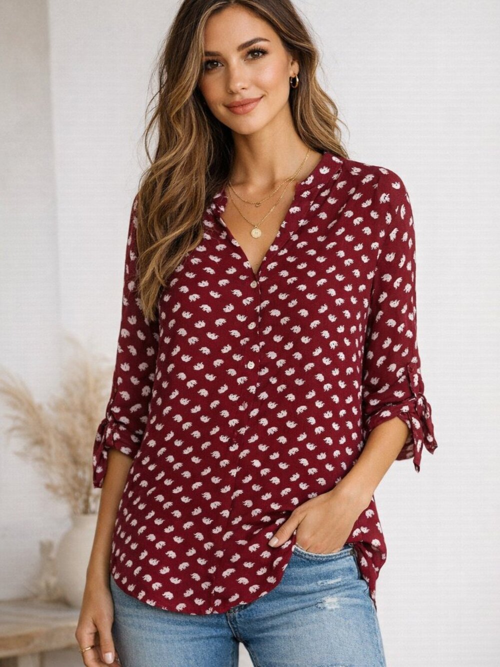 Cals blouse featuring an allover white elephant print on a rich red size medium